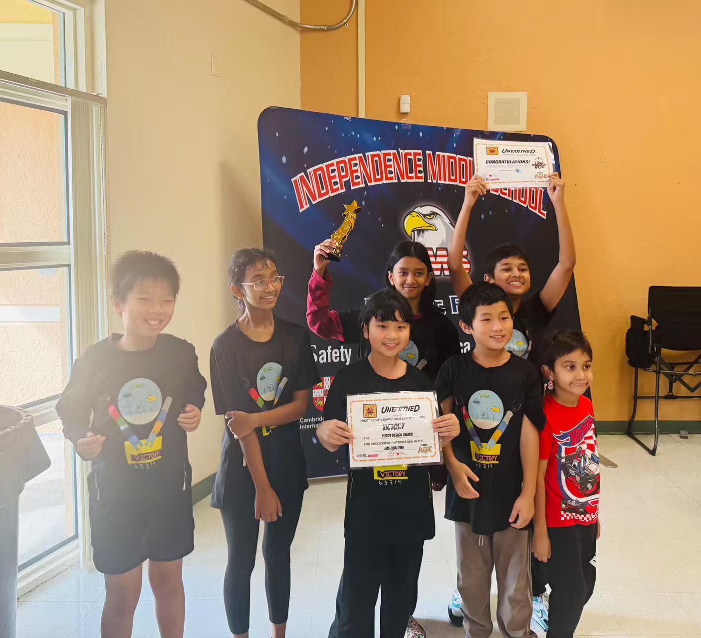 Students holding certificates after a robotics or STEM event