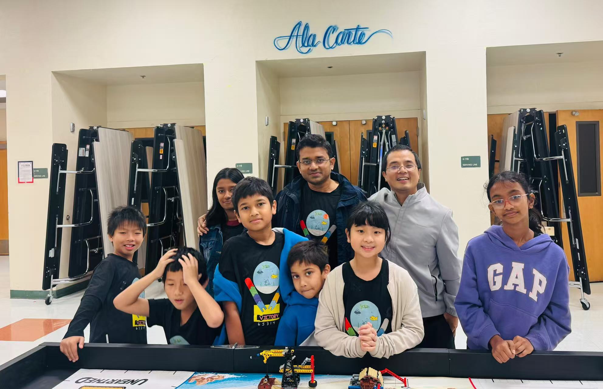 Students and mentors gathered around a robotics activity table