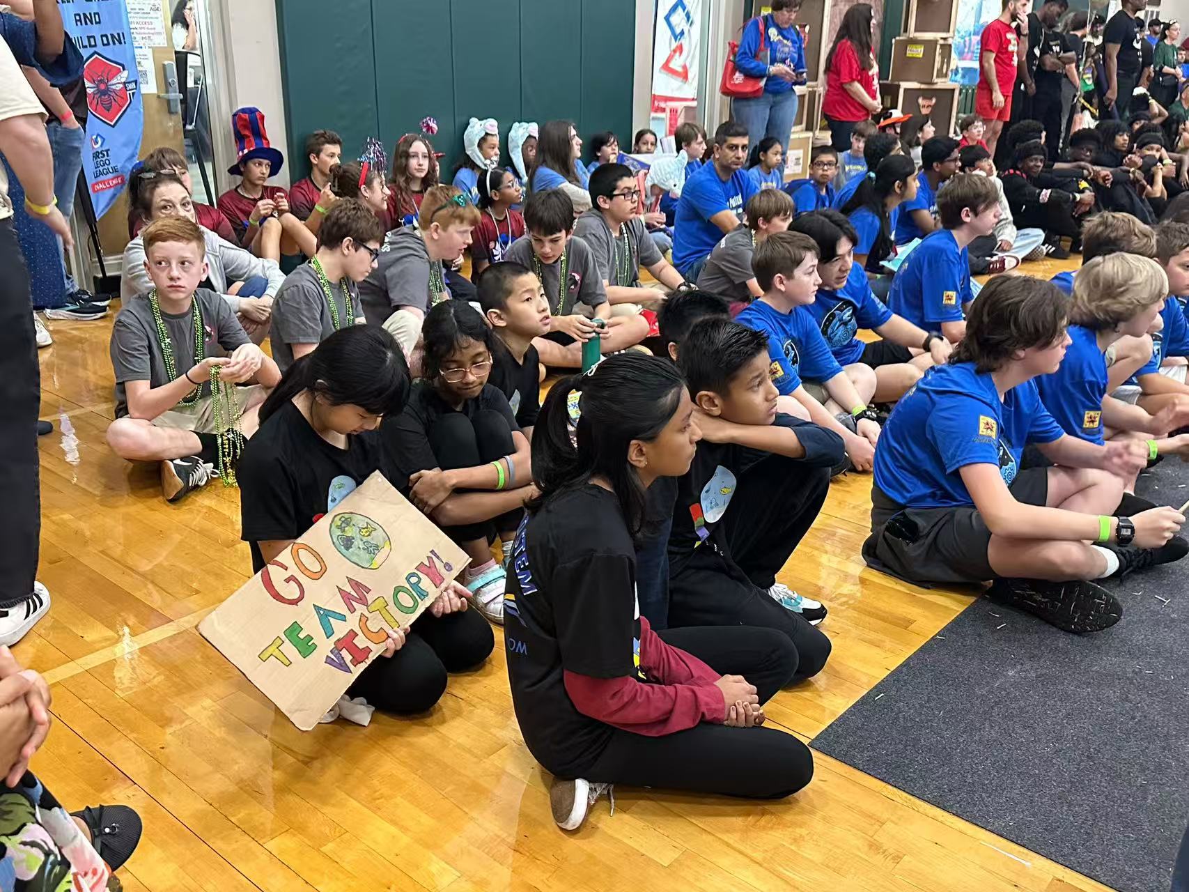 Students seated at a robotics competition event