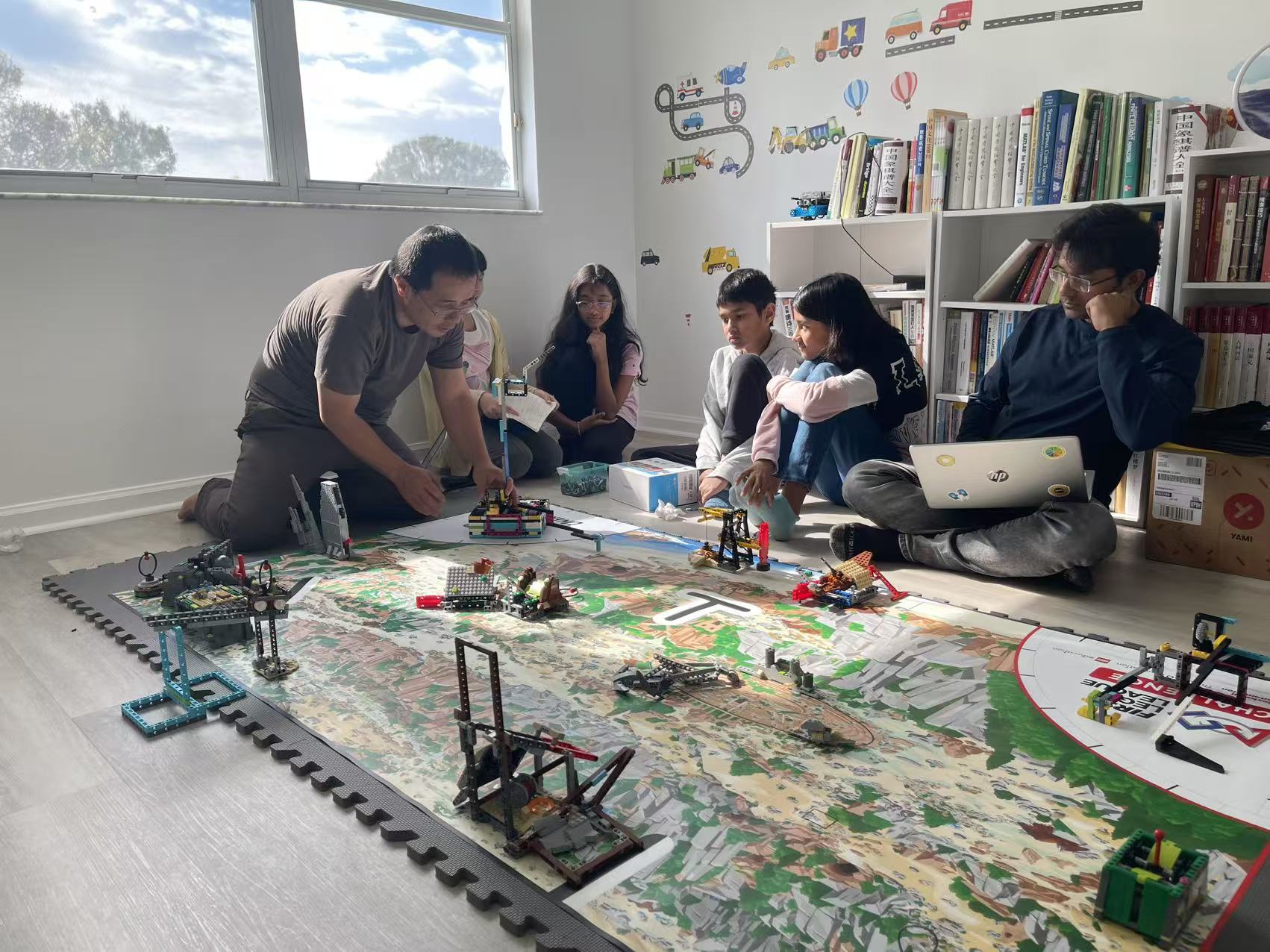Students and mentors working around a robotics competition field