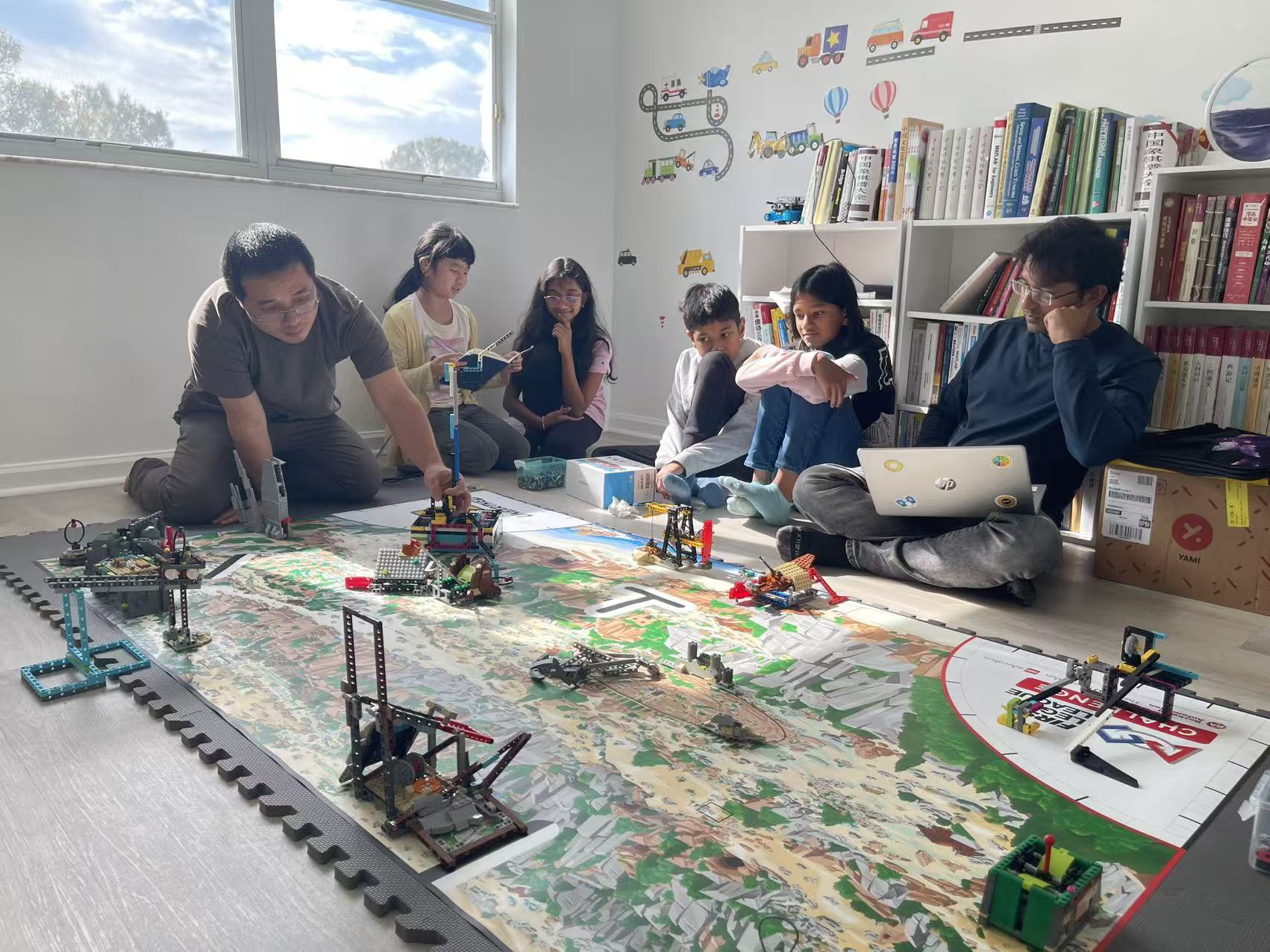 Students and mentors testing robots on a classroom field