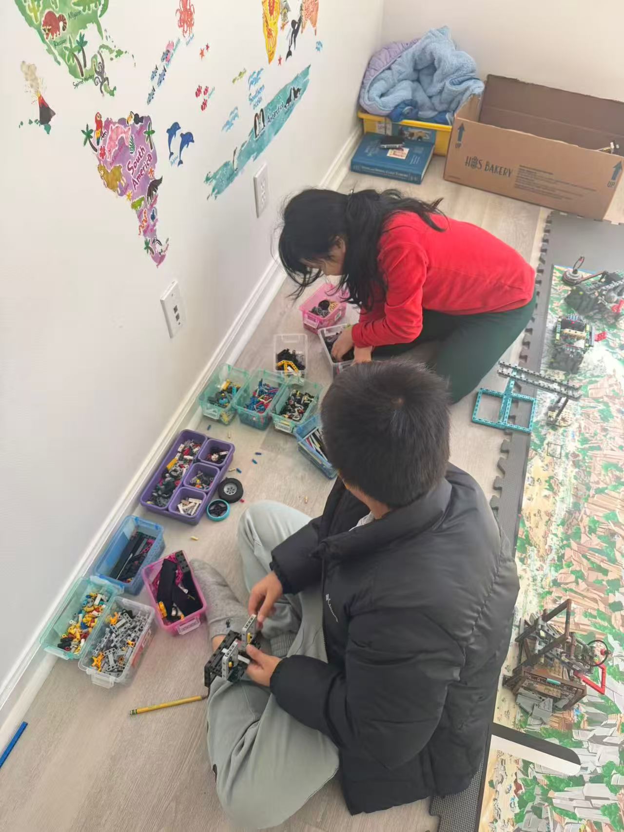 Students organizing robotics parts and materials during a STEM workshop